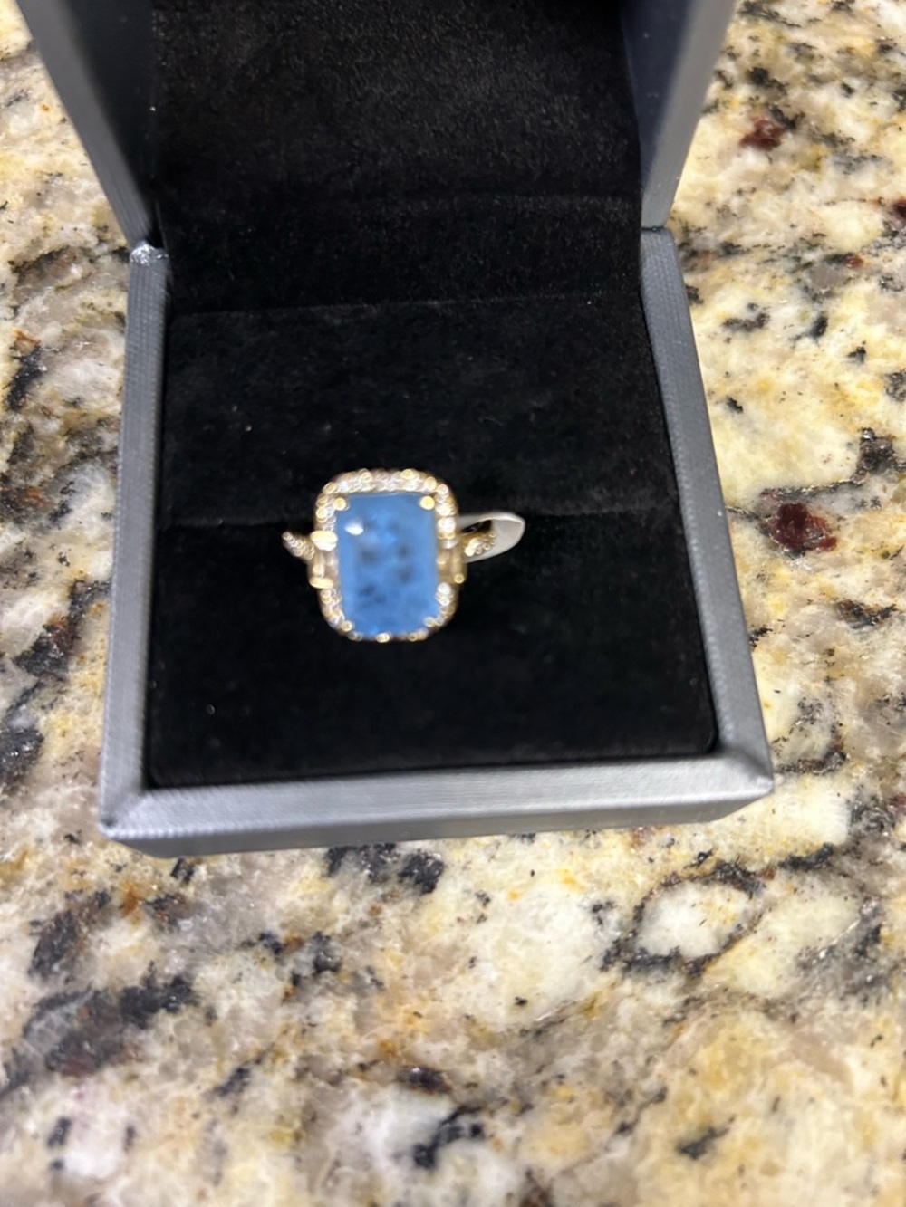 Gold Ring with Blue Rectangular Gem and Pavé Halo